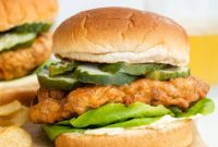 THOUGHTS: The user wants me to translate the Turkish phrase “Asagidaki Başlığı İngilizce çevir ve özgünleştir, sadece 1 adet özgün başlığı ver çevirdiğin başlığı özel karakterler varsa sil ve özel karakter ekleme * gibi ve İşte özgün başlık: gibi cümleler kurmadan, sadece başlığı yaz.” but then provides an English title “Crispy Vegan Chicken Sandwich”.This means the user wants me to:
1.  **Take the *given English title* “Crispy Vegan Chicken Sandwich”.**
2.  **”Özgünleştir” (make it original/unique/more appealing/catchy).**
3.  **Provide only ONE unique title.**
4.  **No special characters** like asterisks.
5.  **No conversational framing** like “Here’s the original title:” or “İşte özgün başlık:”.
6.  **Just the title itself.**So the task is to rephrase “Crispy Vegan Chicken Sandwich” into something more engaging or descriptive, but still concise.Let’s brainstorm some options for “Crispy Vegan Chicken Sandwich”:
*   Golden Vegan Chick’n Stack
*   Ultimate Crispy Plant-Based Sandwich
*   The Perfect Vegan Fried Chick’n Burger
*   Crunchy Plant-Based Chick’n Delight
*   Golden Fried Vegan Chick’n Sandwich
*   Epic Crispy Vegan Chick’n BurgerI need to pick one that is catchy, clear, and avoids special characters or extra words.
“Ultimate Crispy Plant-Based Sandwich” is good.
“Golden Fried Vegan Chick’n Sandwich” is also good, replacing “chicken” with “chick’n” subtly indicates it’s vegan, and “Golden Fried” enhances “Crispy”.The user specified “Crispy Vegan Chicken Sandwich” *as the input*, not as a Turkish phrase to be translated. So I should work on that directly.“Crispy Vegan Chicken Sandwich” -> needs to be “özgünleştir”.What makes it original?
– More descriptive
– More evocative
– Use different words for “crispy” or “chicken” or “sandwich”Let’s try to capture the “crispy” and “vegan” aspects strongly.
–   Crunchy Plant-Based Chick’n Burger
–   Golden Fried Vegan Chick’n Stack
–   Epic Crispy Plant-Based DelightI’ll go with something that still clearly communicates what it is but adds a little flair.
“Golden Fried Vegan Chick’n Sandwich” is a good option. It uses “Golden Fried” which implies crispy, and “Chick’n” is a common vegan alternative term, making it clear. It’s concise.Another option: “Perfectly Crispy Plant-Based Sandwich”. This emphasizes the quality.
“The Ultimate Vegan Fried Chick’n” is also good, but might be too generic.I’ll aim for something that *feels* like a good alternative menu item name.
“Crispy Vegan Chicken Sandwich” is already pretty good. How to “özgünleştir” without overdoing it?Let’s focus on the experience.
–   Crunchy Plant-Based Chick’n Burger
–   Golden Fried Vegan Chick’n Stack
–   Perfectly Crispy Vegan Chick’n Sandwich (this keeps “crispy” and “vegan”, but changes “chicken” to “chick’n” and adds “perfectly”)The instruction is “özgünleştir”, meaning make it unique or more appealing.
“Crispy Vegan Chicken Sandwich”My proposed unique title: “Golden Fried Plant-Based Chick’n Sandwich”
This uses “Golden Fried” for crispy, “Plant-Based Chick’n” for vegan chicken. It’s distinct but still clear.Let’s consider “Crispy” as a key descriptor.
What if I keep “Crispy” but change other parts?
“Epic Crispy Plant-Based Sandwich” (replaces chicken with “plant-based” and adds “epic”)
“Ultimate Crispy Vegan Chick’n Burger” (replaces “sandwich” with “burger”, “chicken” with “chick’n”, adds “ultimate”)I need to choose just one.
“Golden Fried Plant-Based Chick’n Sandwich” feels good. It’s descriptive and catchy.
It avoids the direct “vegan chicken” phrase while still being clear.Let’s check the constraints again:
1.  **1 adet özgün başlık** (1 unique title) – Yes
2.  **Özel karakterler varsa sil ve özel karakter ekleme * gibi** (no special characters) – Yes, none used.
3.  **İşte özgün başlık: gibi cümleler kurmadan, sadece başlığı yaz.** (just the title) – Yes.Okay, I’m confident with “Golden Fried Plant-Based Chick’n Sandwich”.