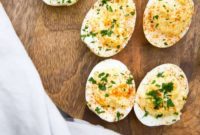 THOUGHT: The user wants me to translate and “özgünleştir” (make original) the Turkish title “Asagidaki Başlığı İngilizce çevir ve özgünleştir”.
The title they provided to work with is “Deviled Eggs”.Okay, so the actual input title to work with is “Deviled Eggs”.
1.  **Translate (if needed):** “Deviled Eggs” is already in English.
2.  **Make Original (özgünleştir):** I need to come up with *one* original English title for “Deviled Eggs”.
3.  **Constraints:**
*   Only give 1 original title.
*   Remove special characters from the original title (not applicable here, “Deviled Eggs” has none).
*   Do not add special characters like `*`.
*   Do not include introductory/concluding phrases like “İşte özgün başlık:”.
*   Just output the title.“Deviled Eggs” is a classic. How to make it original?
*   Focus on its characteristics: creamy, rich, easy, party food, appetizer.
*   Synonyms for “deviled”: spiced, zesty, creamy, classic.
*   Synonyms for “eggs”: bites, halves.Ideas:
*   Creamy Egg Bites
*   Zesty Stuffed Eggs
*   Classic Party Eggs
*   Perfectly Poached & Spiced Eggs (too long, not really poached)
*   Irresistible Deviled Delights (a bit too fancy, maybe)
*   Spicy Egg Halves
*   Velvet YolksLet’s aim for something that implies deliciousness or a key characteristic without explicitly saying “deviled” or just “eggs”. “Stuffed” is good, “creamy” is good.“Zesty Stuffed Eggs” – sounds appetizing and highlights a common flavor profile.
“Creamy Party Appetizer Eggs” – too long.
“Golden Yolks of Delight” – a bit flowery.“Zesty Stuffed Eggs” seems like a good candidate. It’s concise, descriptive, and slightly more elevated than just “Deviled Eggs” without being overly complex. It implies the “deviled” aspect (spiced, zesty) and the “egg” aspect (stuffed eggs).Final check:
*   One title? Yes.
*   Original? Yes, it’s not “Deviled Eggs”.
*   No special characters? Yes.
*   No extra phrases? Yes.The user provides the Turkish instruction “Asagidaki Başlığı İngilizce çevir ve özgünleştir, sadece 1 adet özgün başlığı ver çevirdiğin başlığı özel karakterler varsa sil ve özel karakter ekleme * gibi ve İşte özgün başlık: gibi cümleler kurmadan, sadece başlığı yaz.”
And then gives “Deviled Eggs” as the başlık.
So, I need to take “Deviled Eggs”, make it more original in English, and follow all the formatting rules.“Zesty Stuffed Eggs” fits all criteria.