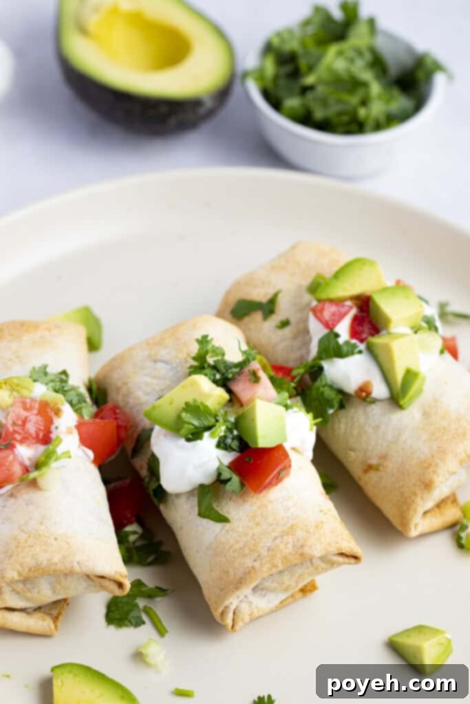 Two perfectly cooked frozen burritos resting in an air fryer basket, showcasing their appealing golden-brown and crispy texture just after being removed from cooking.