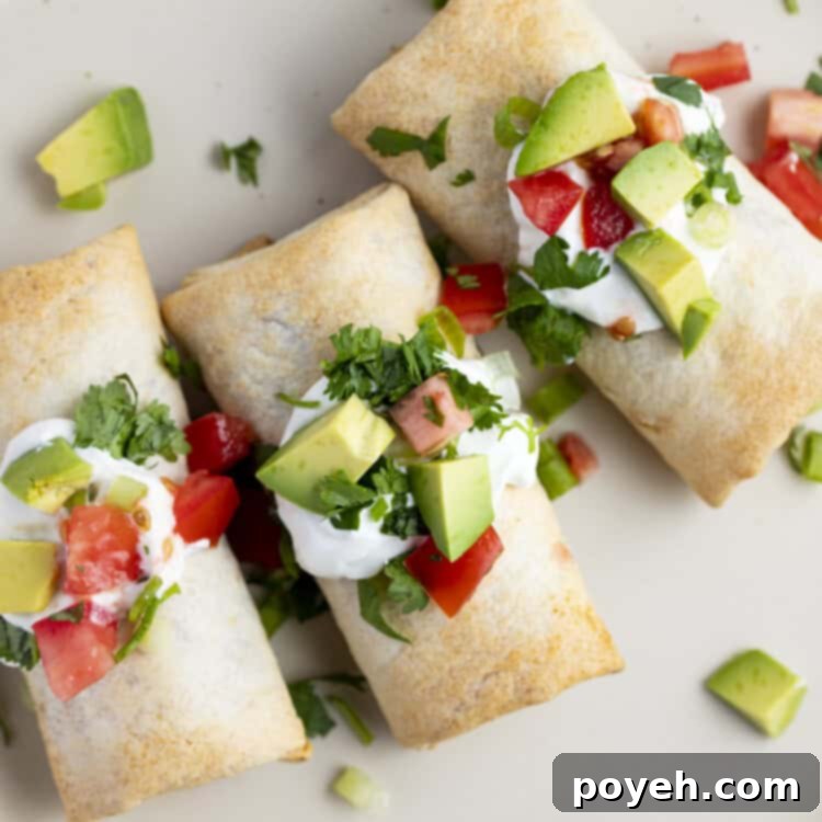 Frozen burritos cooked in the air fryer topped with pico, guacamole, and sour cream