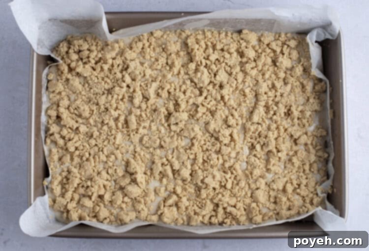 Top layer of vegan coffee cake in 9x13 baking dish with parchment paper