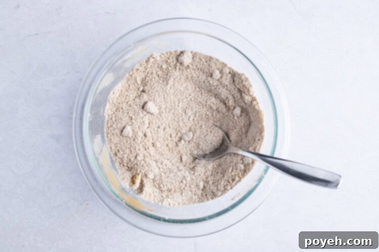 Cinnamon-sugar filling mixture in glass bowl with spoon