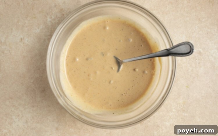 Burger sauce in glass bowl with spoon