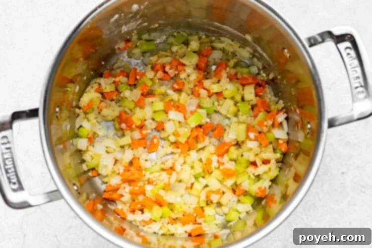 After sautéing vegetables, flour is added to the pot and stirred for one minute, creating a roux to thicken the soup, with Italian seasoning, salt, and black pepper already blended in.