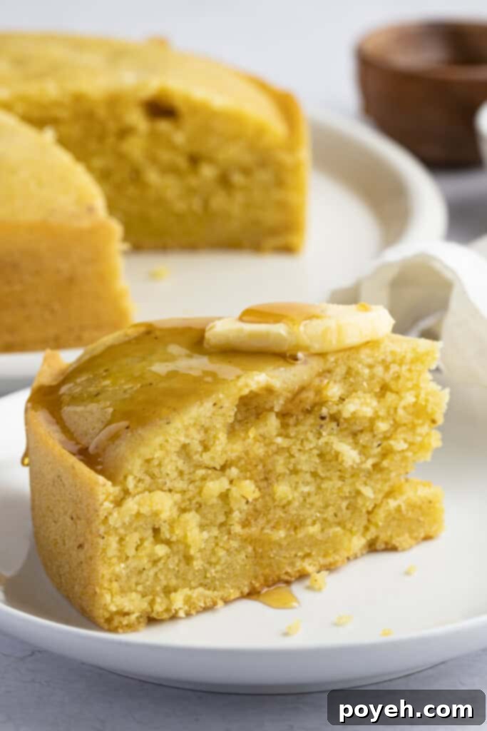 Instant Pot cornbread cut into a wedge, showcasing its moist texture