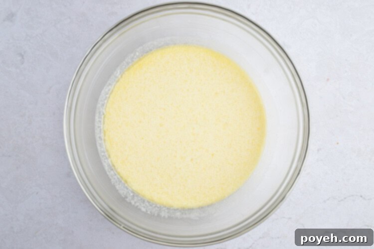 Wet ingredients for Instant Pot cornbread in a large glass bowl