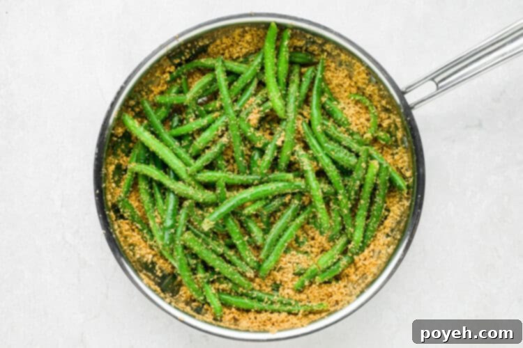 Garlicky Italian Green Beans 7 Italian green beans step 2: Tossing pre-cooked green beans with the toasted breadcrumb and parmesan mixture in a skillet.