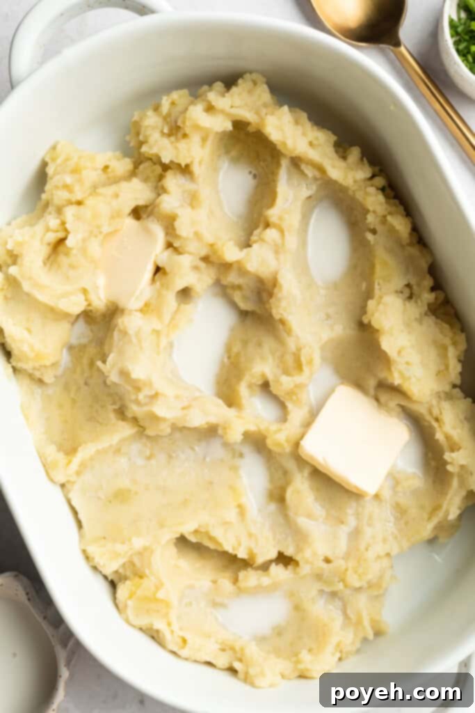 mashed potatoes in a baking dish with milk and butter