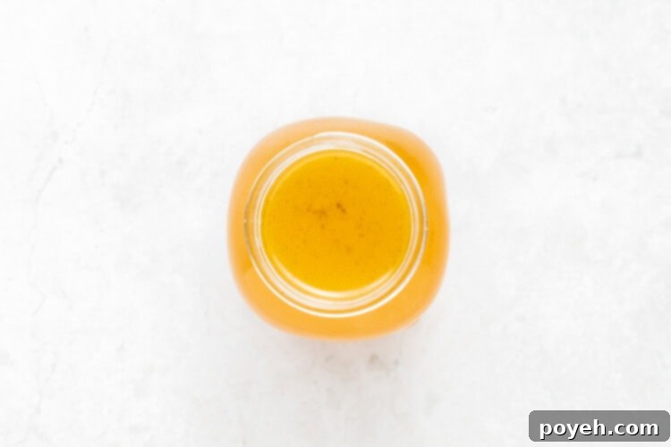 Straining the Instant Pot turkey stock into a large bowl