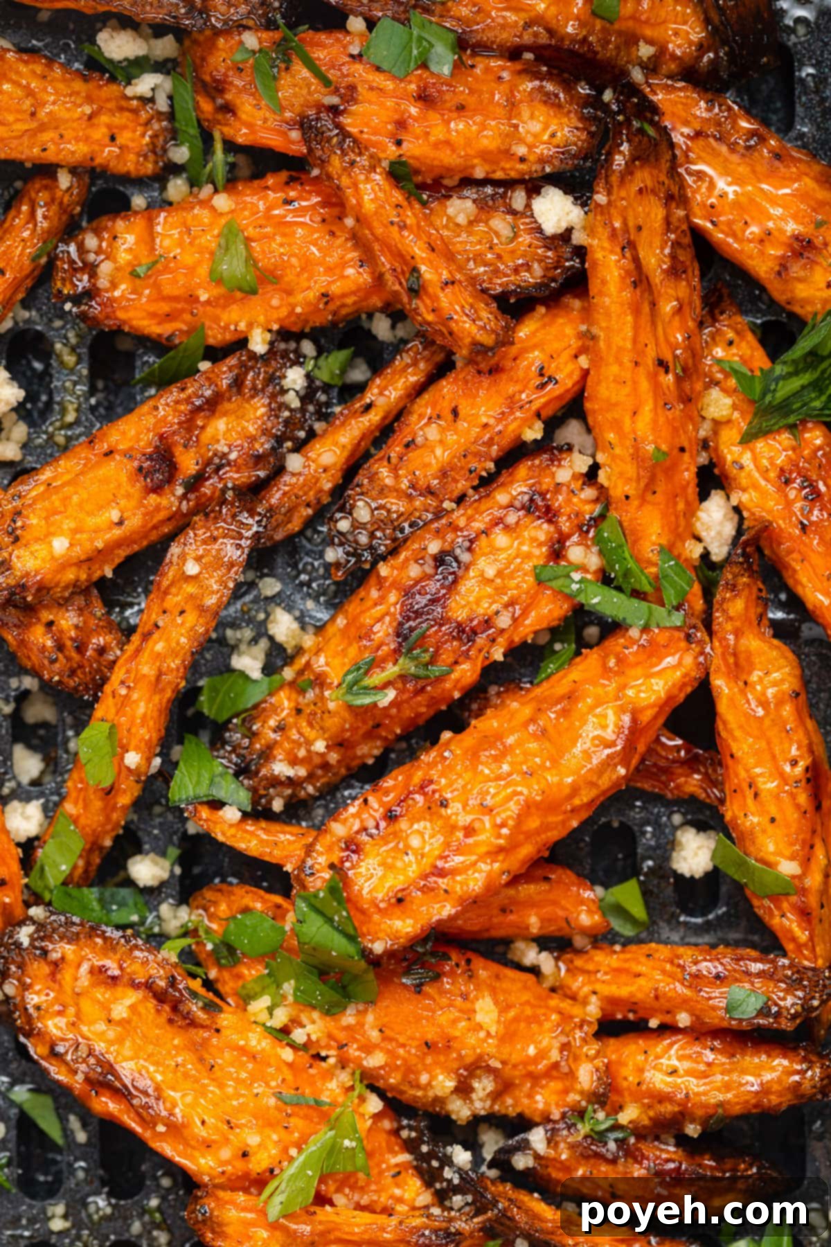Golden brown air fryer carrots ready to serve, in an air fryer basket.