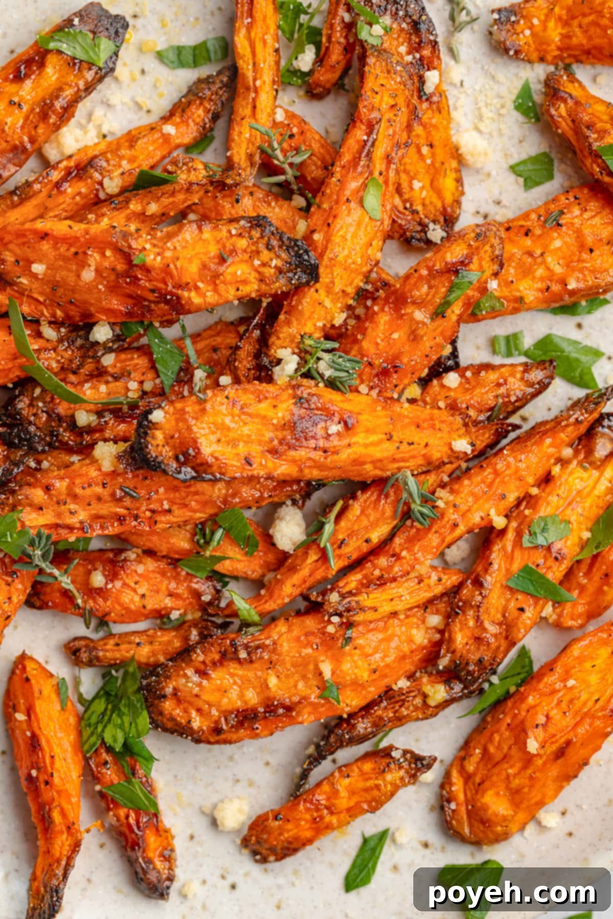 A vibrant plate of air fryer carrots, garnished with fresh herbs.