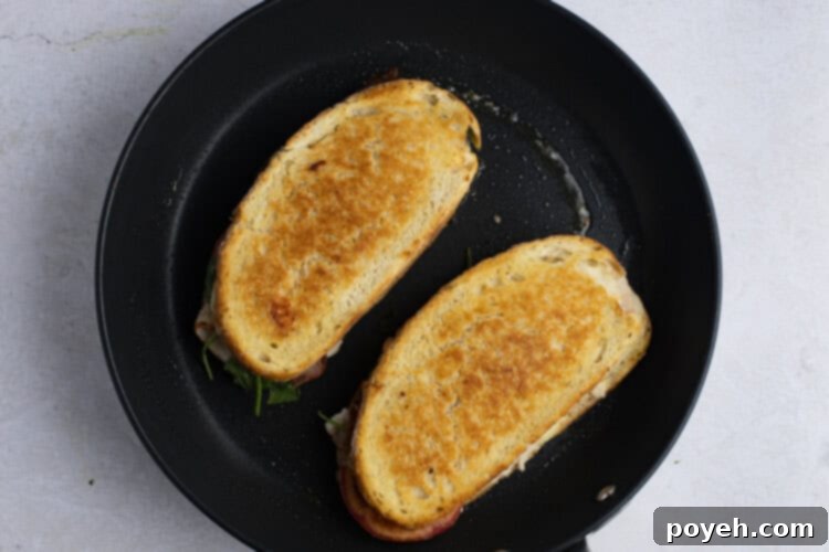 Toasted turkey melt sandwiches in cast iron skillet