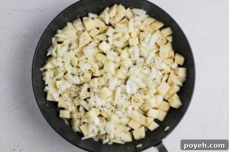 Potatoes and onions in large skillet before cooking