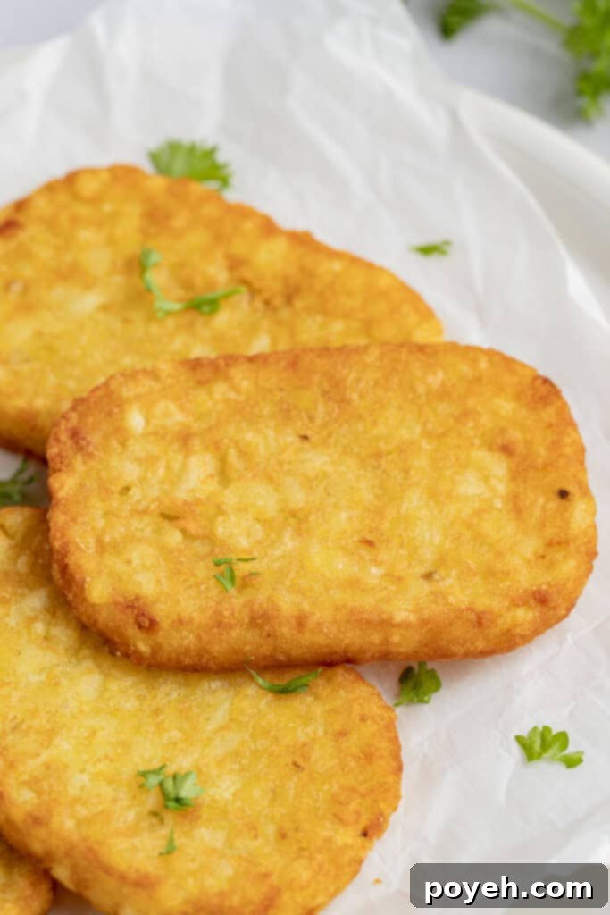 Freshly cooked hashbrowns in the air fryer, presented beautifully on a plate, hot and ready to eat