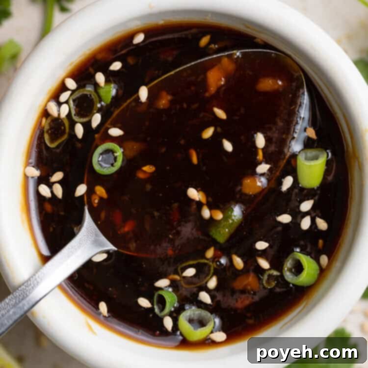 Close-up image of a luscious keto teriyaki sauce in a ceramic dish, highlighting its rich, glossy texture and enticing dark color, ready to be enjoyed.