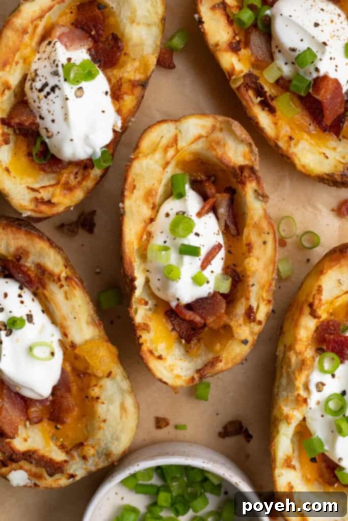 overhead image of air fryer potato skins with chopped green onion on the side