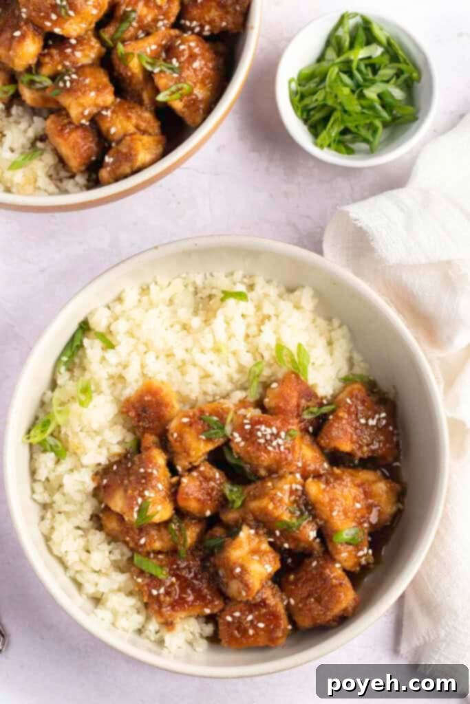 Overhead view of keto orange chicken with cauli rice in a bowl