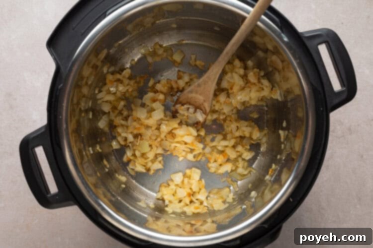 Sautéing onions and garlic in the Instant Pot for Chicken Paprikash base.
