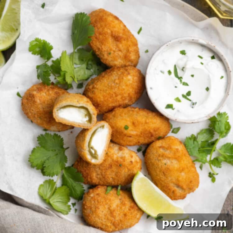 Air Fried Crispy Frozen Jalapeño Poppers 4 overhead image of air fryer frozen jalapeno poppers on a plate with cilantro lime dipping sauce on the side