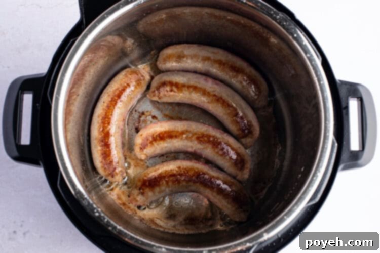 Overhead photo of bratwurst in Instant Pot with melted butter.
