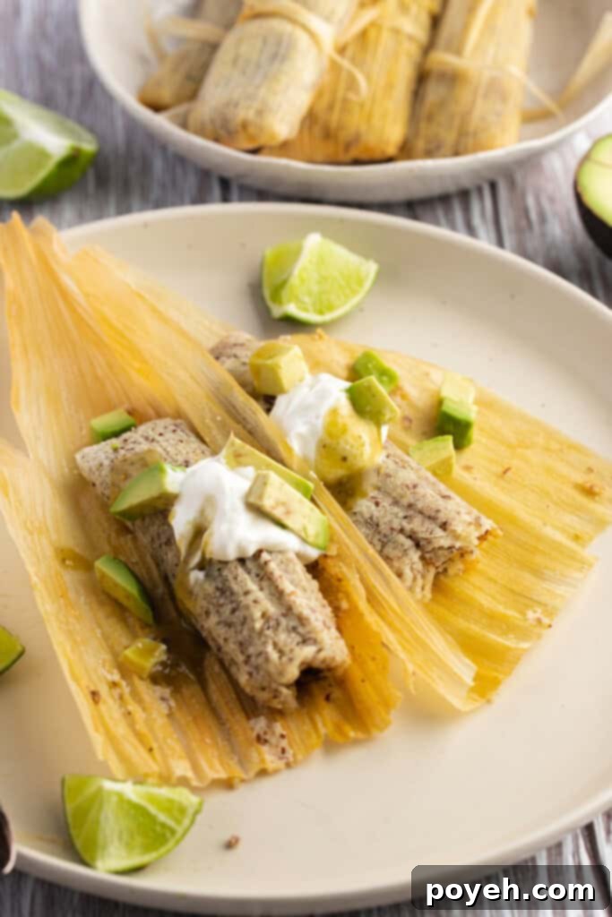 Authentic-looking keto tamales nestled in corn husks, arranged artfully on a neutral plate against a warm, dark brown background, highlighting their delicious appeal.