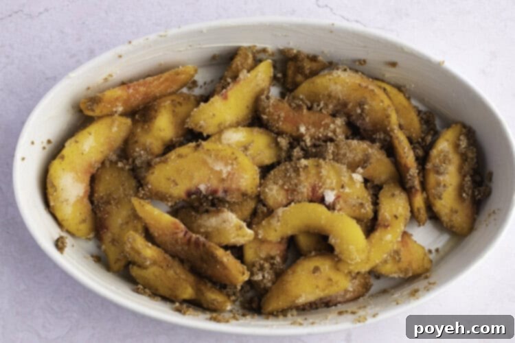 Keto peach filling in a large white oval baking dish.