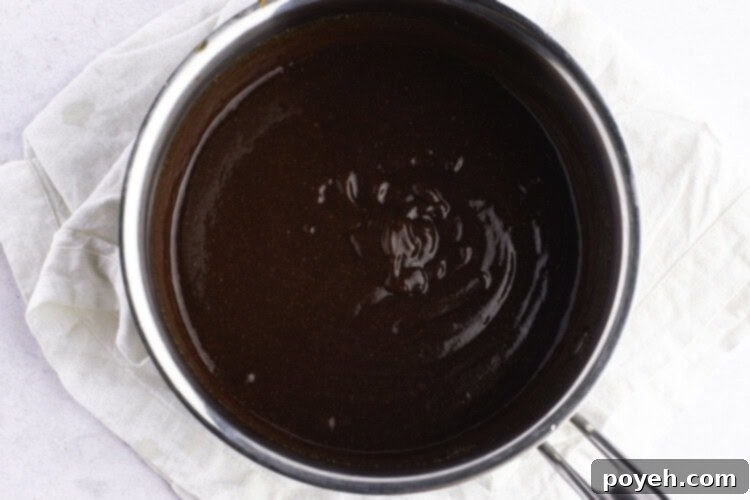 Overhead, close-up view of vegan bbq sauce in a silver saucepan.