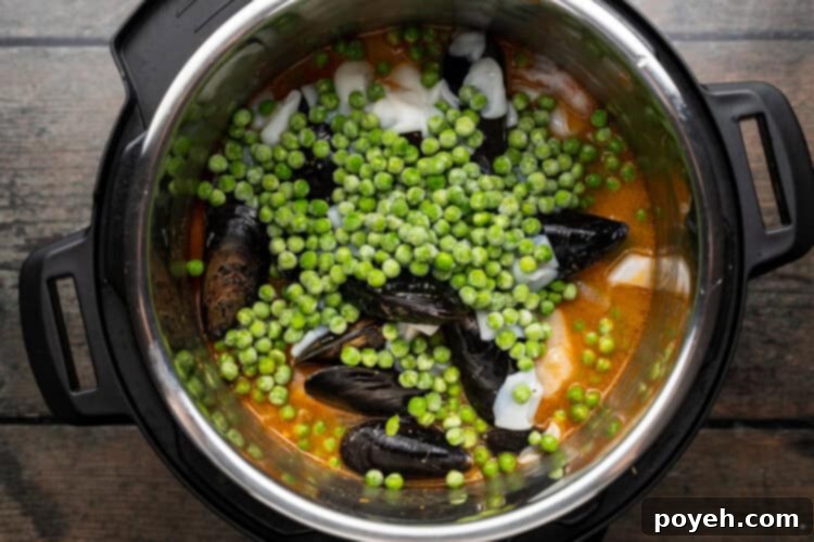 Overhead view of paella ingredients in an Instant Pot.