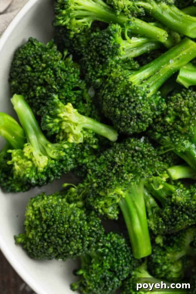 Close-up view of sous vide broccoli in a white bowl, showing its fresh green color.