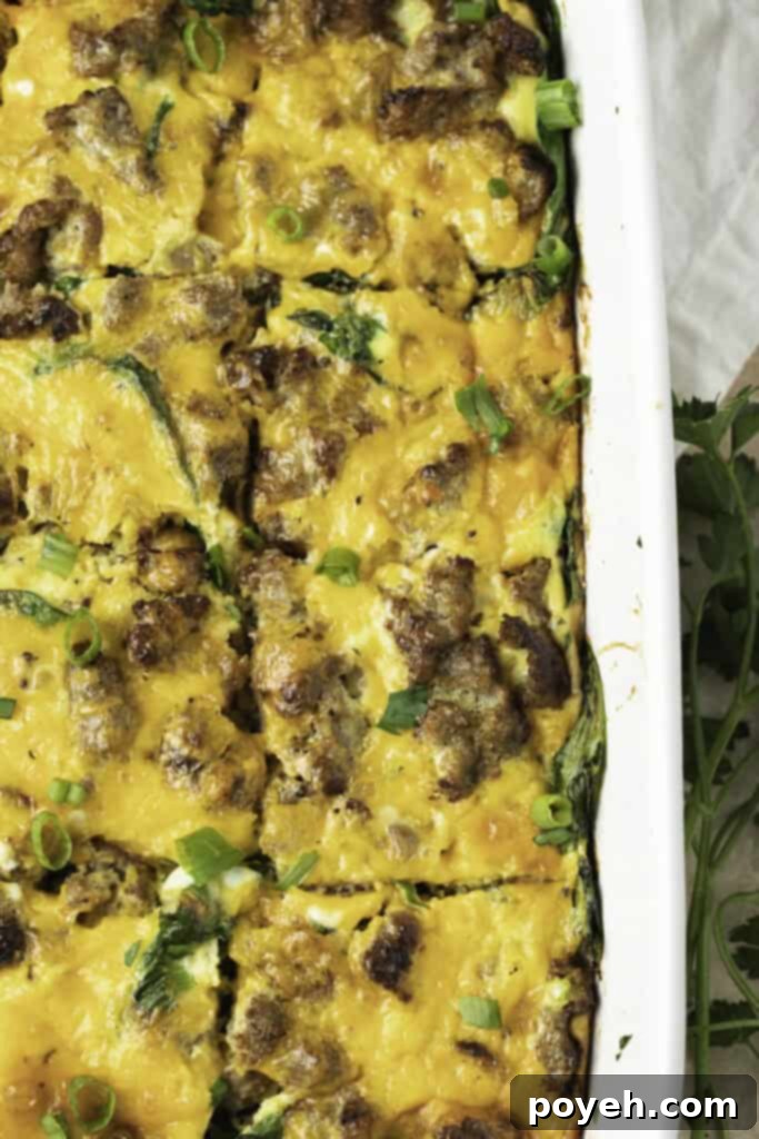 Overhead view of keto breakfast casserole in a white casserole dish, with the casserole cut into squares.