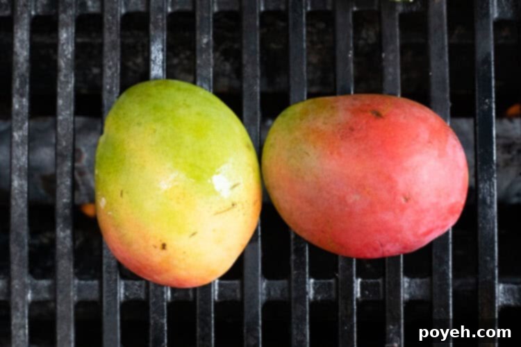 Mangoes cut-side down on grill, showing beautifully executed char marks and tender texture.