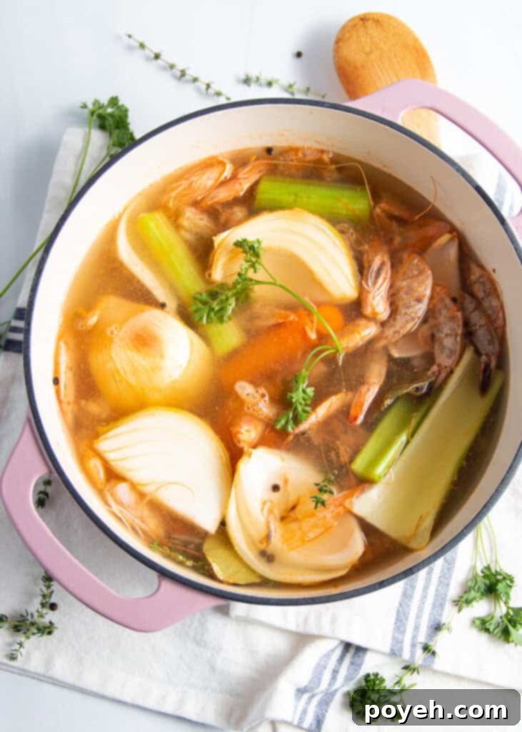 Savory Shrimp Stock from Scratch 3 Overhead view of ingredients for shrimp stock in a large, heavy-bottomed stock pot.