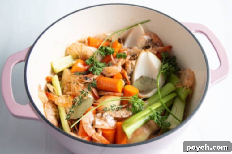 Savory Shrimp Stock from Scratch 7 Overhead view of all shrimp stock ingredients in large dutch oven.