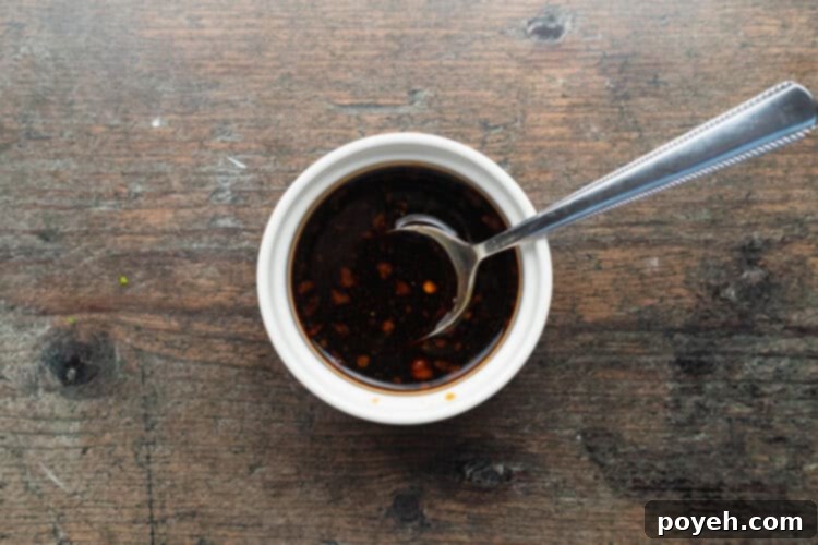 Overhead view of a dipping sauce for air fryer dumplings in a small ramekin on a wooden table.