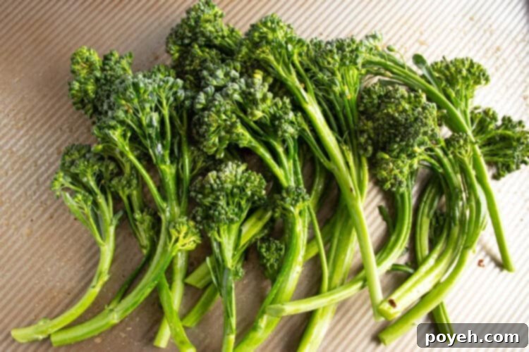 Trimmed broccolini on a cutting board.