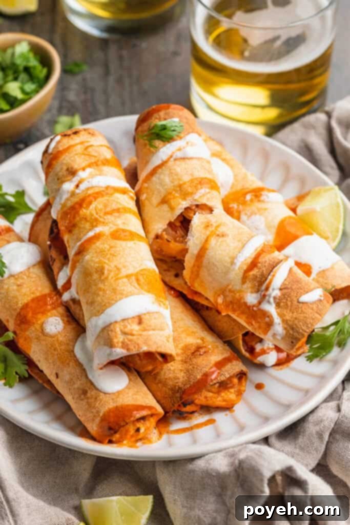 Crispy air fryer chicken flautas on a paper plate, beautifully garnished with fresh cilantro and a dollop of sour cream, surrounded by various dipping sauces like guacamole, salsa, and queso.