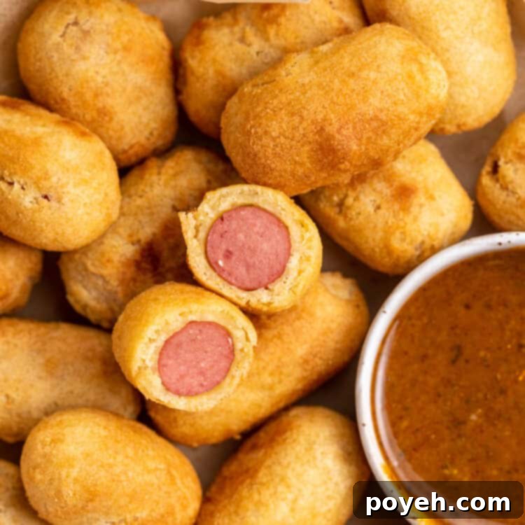 Closeup view of air fryer mini corn dogs with smoky mustard sauce.
