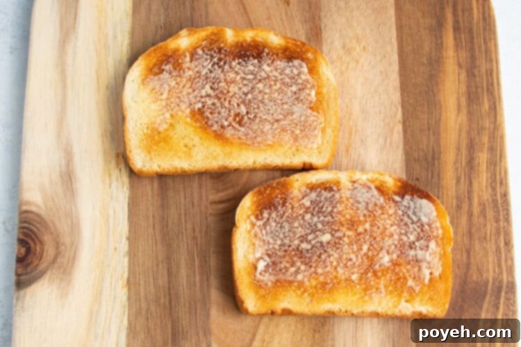 Buttered toast on a cutting board.