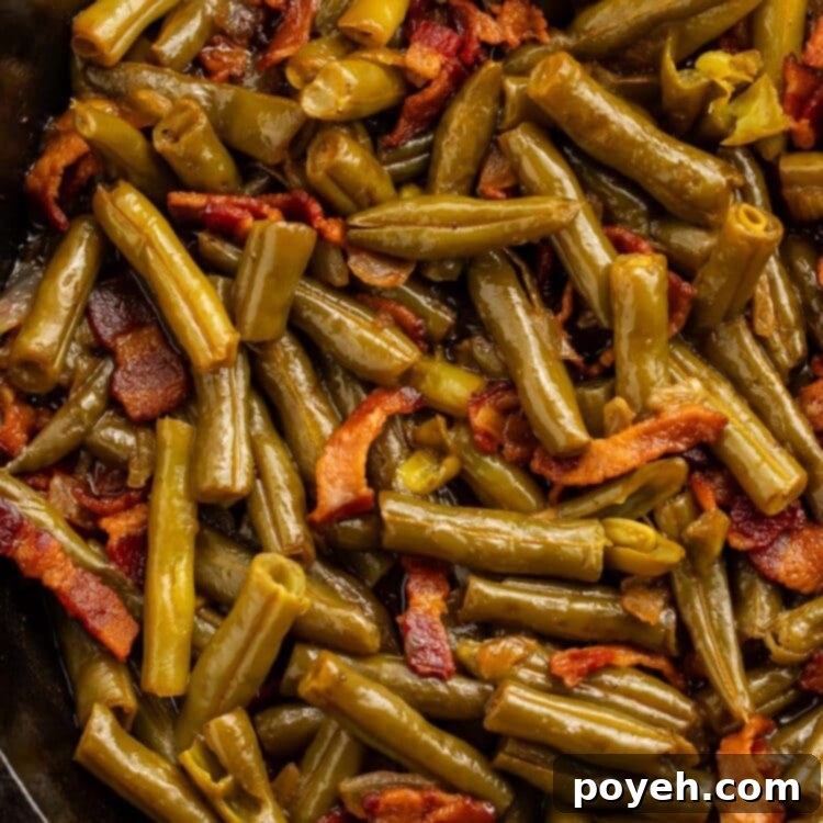 Copycat Texas Roadhouse green beans with bacon in a large cast iron skillet.