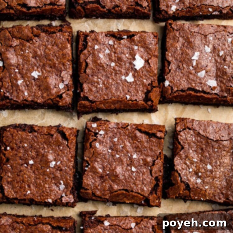A photo, taken from above, shows 4 rows of 3 brownies on a sheet of parchment paper.