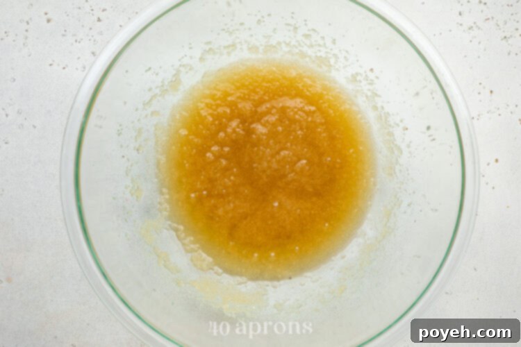 Wet ingredients for dairy free brownies in a large glass mixing bowl.