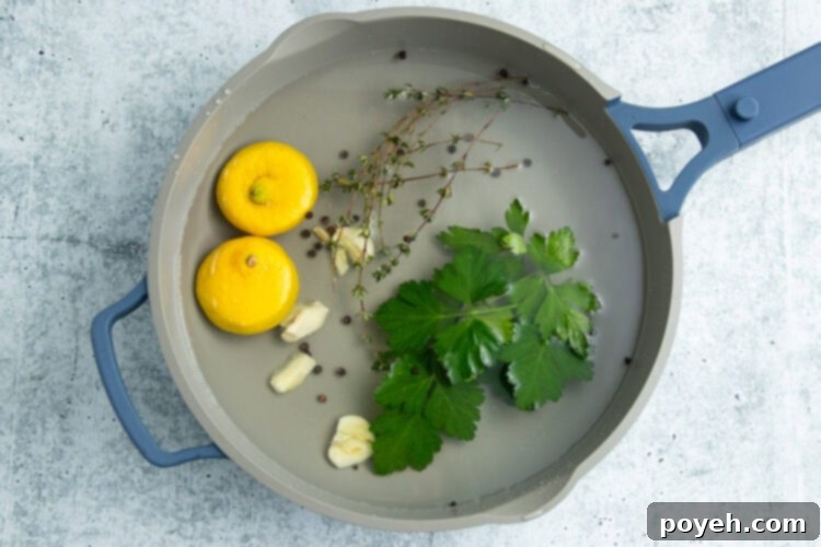 Aromatics for poached shrimp simmering in a large pot.
