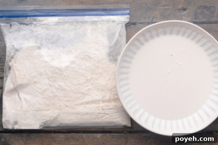 Buttermilk in a shallow bowl and breading mixture in a plastic bag for truffle honey chicken.