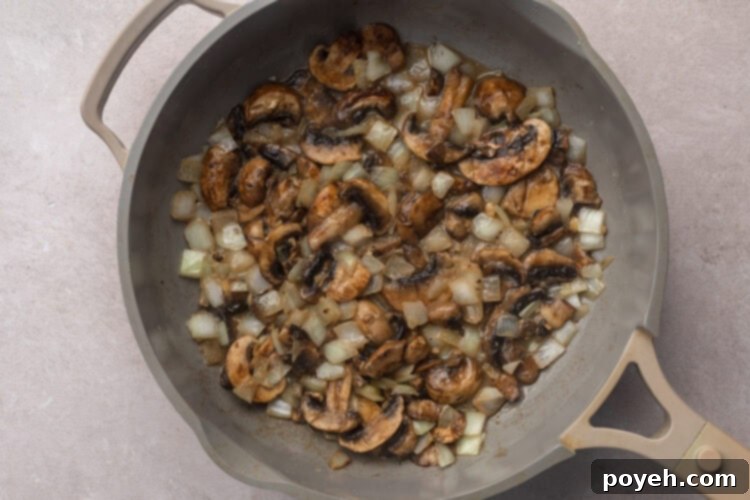 Sautéed mushrooms and chopped onions in a large skillet with melted butter.