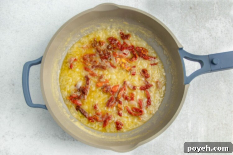 Melted butter with sun-dried tomatoes in a large skillet.