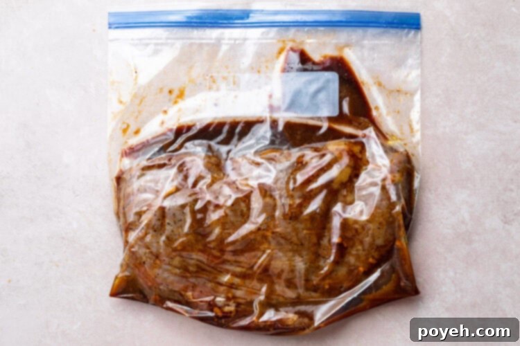 Cooked sous vide flank steak in large ziploc bag with remaining marinade.