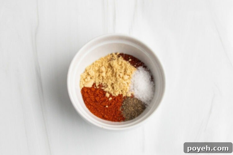 Dry rub spice blend ingredients in medium white bowl.
