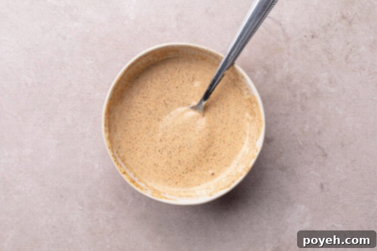 Zesty Tuna Crunch 8 Creamy chipotle aioli prepared in a small mixing bowl, ready to drizzle.