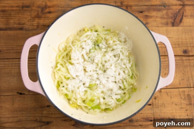 Onions and celery in a large pot with minced garlic and thyme.