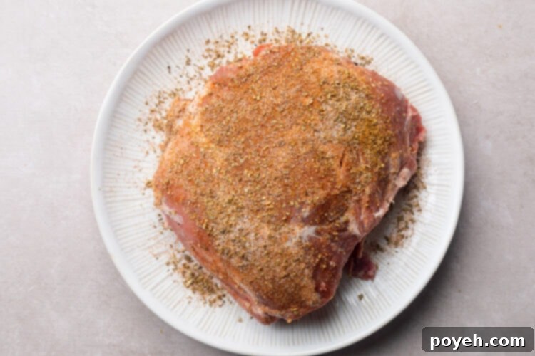 2 pound pork shoulder coated in spice rub.